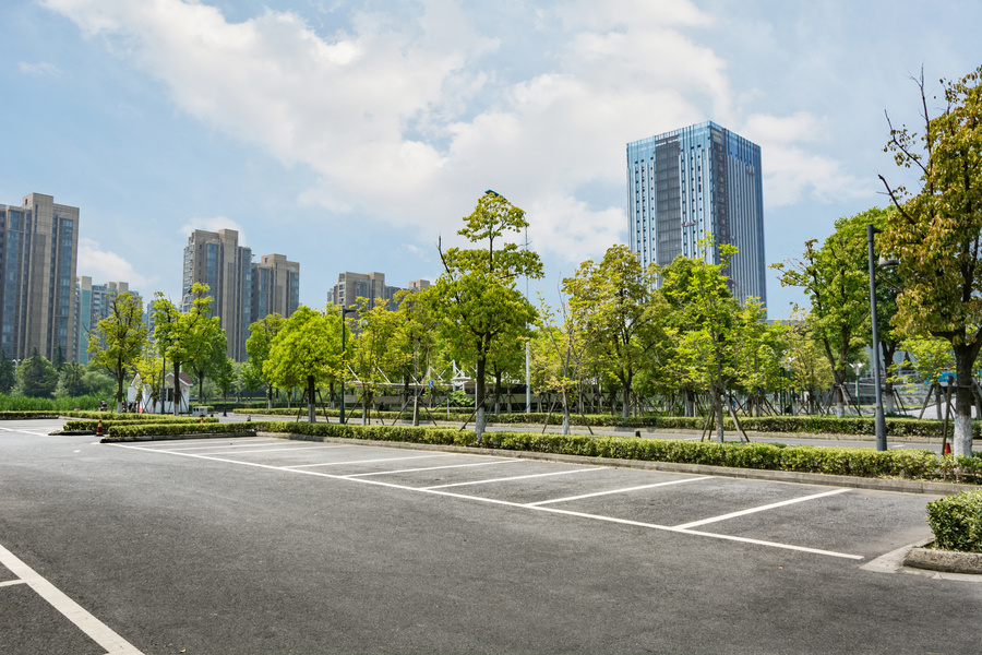 Freshly striped car parking lot with white pavement markings by Sunshine Services Unlimited.