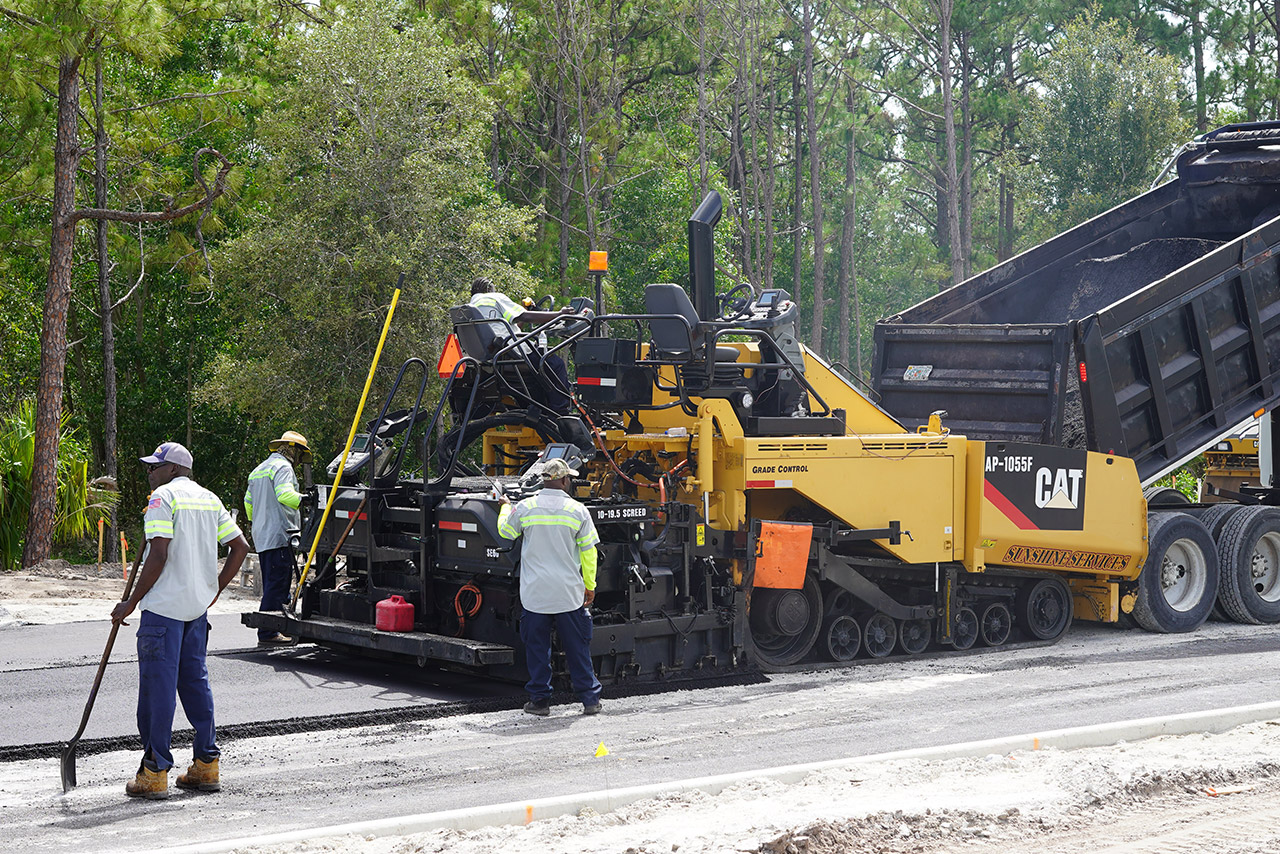 crew laying down asphalt